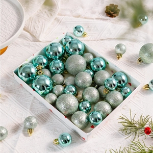 Detail of mint green Christmas ball ornaments set with glitter and matte finishes in a box