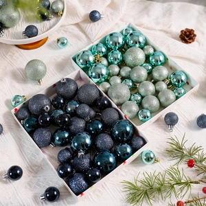 Detail of teal and navy Christmas ball ornaments with glitter, matte and glossy finishes