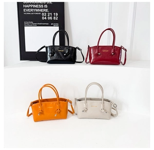 Mini handbag display in black, red, orange, and white with detachable shoulder straps