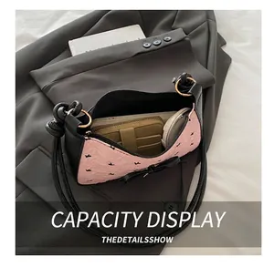 Interior view of the crescent shoulder bag showing space for phone and wallet