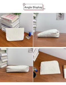 Detail view of white corduroy makeup bag showing multiple angles on a wooden desk