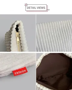 Detailed macro view of white corduroy fabric texture and gold zipper of the clutch bag
