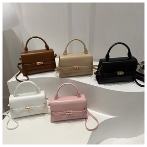 Classic small crossbody square bag in five colors displayed on minimalist white stands