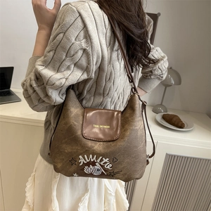 Retro brown textured shoulder bag with chic illustration and adjustable leather strap