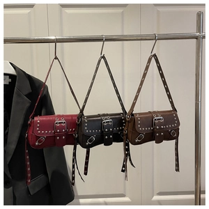 Close-up of vintage punk baguette bags with silver studs in red, brown and coffee colors