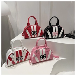 Close-up of four trendy PU leather bowling bags in assorted colors with number 96 patch