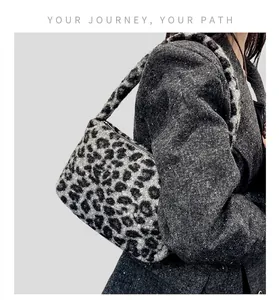 Close-up of leopard print plush shoulder bag with soft faux fur texture and autumn style