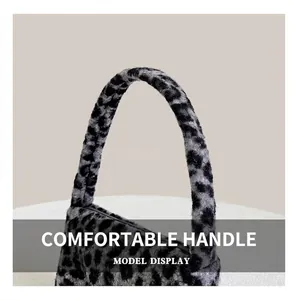 Detail of the soft faux fur leopard print handle with plush grey and black texture