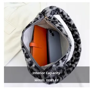 Internal view of leopard print plush bag showing storage for phone and notebook