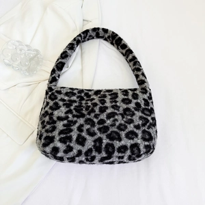 Close-up of leopard print plush shoulder bag with soft faux fur texture and arched strap