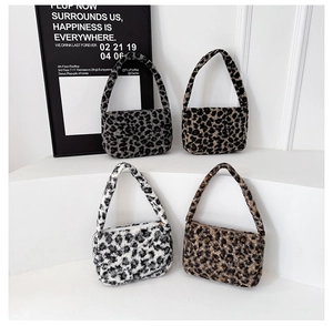 Detailed display of four leopard print plush shoulder bags in various color schemes