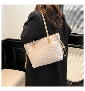 Detail of white plush fleece tote bag with brown PU leather trim and side drawstring