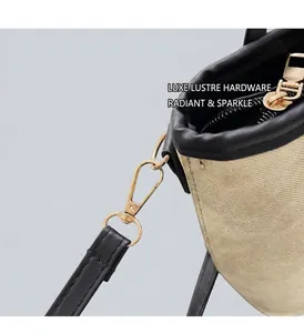 Detailed close-up of premium gold hardware on a retro canvas and leather拼接 handbag