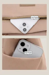 Detail view of large capacity nylon bag showing front zipper pocket and side phone pocket