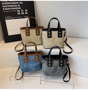Detail shot of vintage bucket bags in four colors with rivet studs and shoulder straps