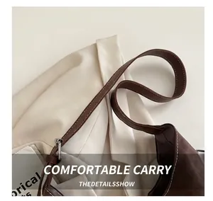 Detail of the brown leather handle with neat stitching on a vintage leopard tote bag