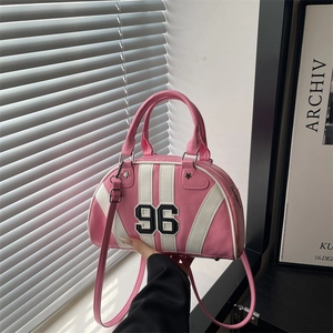 Pink and white Boston bowling bag with 96 print and stars, hand-held in a modern room