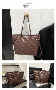 Detail of coffee brown tote bag with embossed bow patterns and drawstring side accents