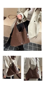 Detail of leopard print faux suede hobo bag with teddy bear charm and adjustable strap