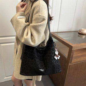 Stylish black leopard print large shoulder bag with a cute plush dog charm