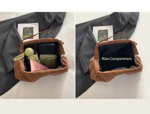 Spacious main compartment of the brown pleated cloud bag showing daily essentials