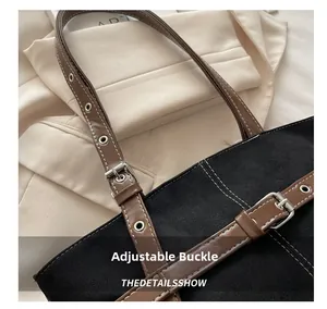 Detail view of adjustable shoulder strap with metal eyelets and contrast stitching