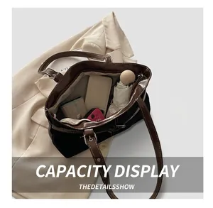 Spacious interior of retro black canvas and brown leather tote bag showing large capacity