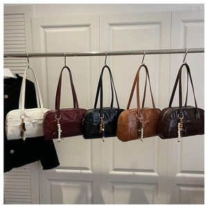 Detail view of five retro shoulder bags in varied colors with decorative wooden beads