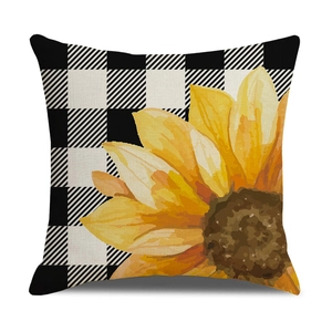 Close-up of linen pillowcase with black buffalo check pattern and sunflower design
