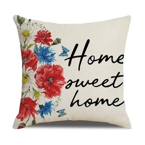 Detail of linen pillowcase featuring red poppies, blue butterflies and Home Sweet Home text