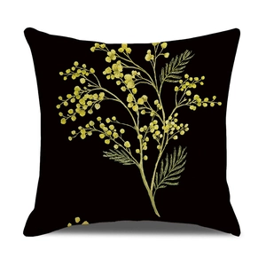 Detail of yellow mimosa flower print on square black linen cushion cover for home decor