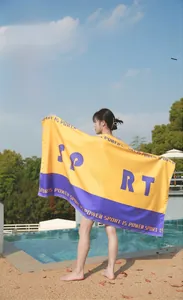 Macro shot of quick-dry microfiber sport beach towel with yellow and purple contrast color