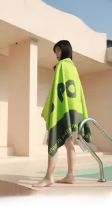 Detail of neon green and grey hooded microfiber sport towel with Sport Is Power text