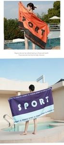 Detail of microfiber sand-free beach towel with SPORT IS POWER slogan by the pool