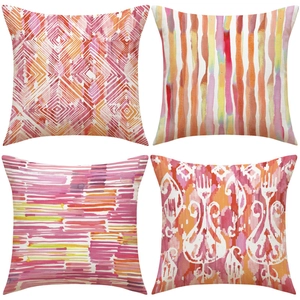 Detail of four linen cushion covers with abstract geometric and watercolor patterns