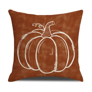 Detailed view of linen texture and white pumpkin print on caramel orange cushion cover