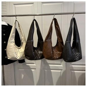 Close-up of bohemian punk star studded underarm bags in four vintage colors