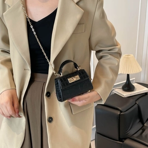 Classic black crocodile pattern handbag with gold clasp and elegant chain strap