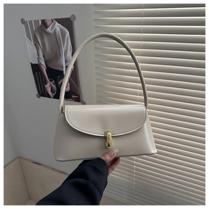 Detailed close-up of cream PU leather handbag featuring a refined gold metal lock and handle