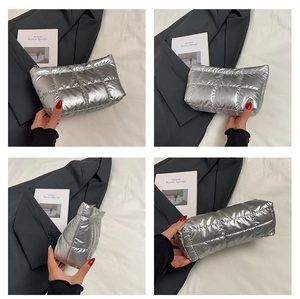 Detailed views of silver quilted puffer clutch featuring square embroidery and metallic finish