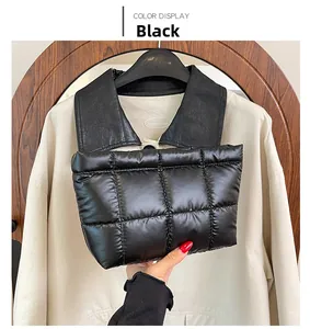 Close-up of black quilted down handbag with puffy texture and rectangular fashion design