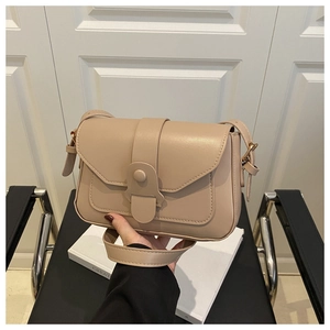 Detailed close-up of a beige PU leather crossbody bag with stitching and clasp buckle