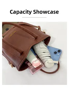 Detail view of the spacious interior of the brown bucket bag showing daily essentials