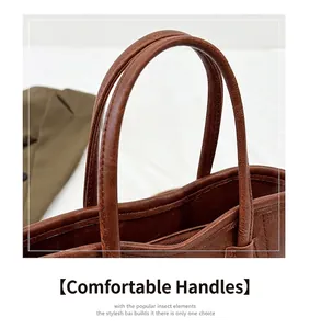 Detail of the brown lychee pattern leather bucket bag with thick rounded handles
