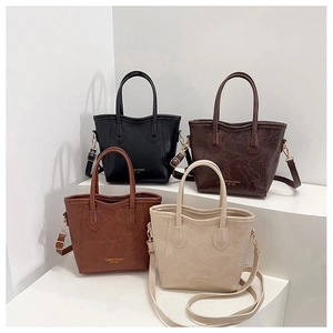 Close-up of four luxury bucket bags in multiple colors with vintage marble leather texture