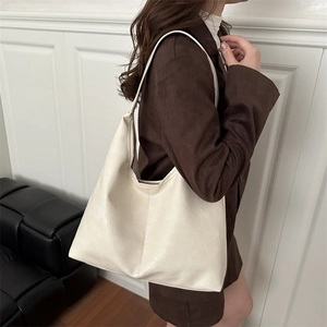 Minimalist beige leather tote bag with pebble texture and large capacity for daily commute