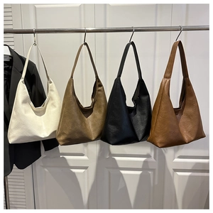Detailed display of vintage pleated leather tote bags in cream, khaki, black and brown