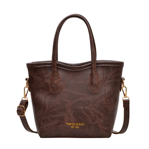Minimalist large brown tote bag in premium faux leather with adjustable shoulder strap