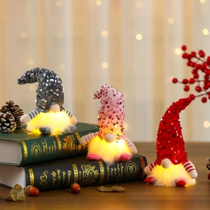 Three-piece glowing Christmas sequin gnomes with warm LED lights and striped sleeves