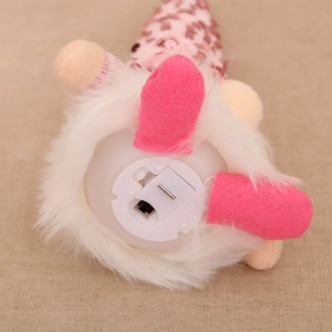 Detail view of the battery compartment and power switch on the plush gnome bottom base